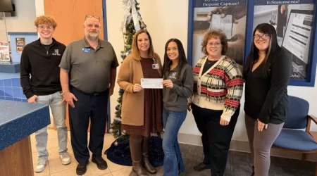 AAACU Team members pose with bags of trash they cleaned up in the community.
